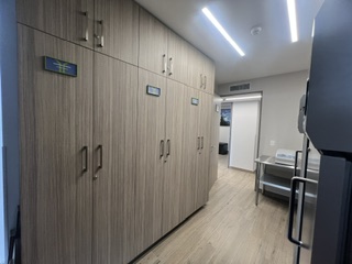 Locked, segregated storage for ambient-temperature IMP, laboratory kits, and ancillary supplies, with the IMP area continuously monitored by three digital maximum/minimum data loggers.
